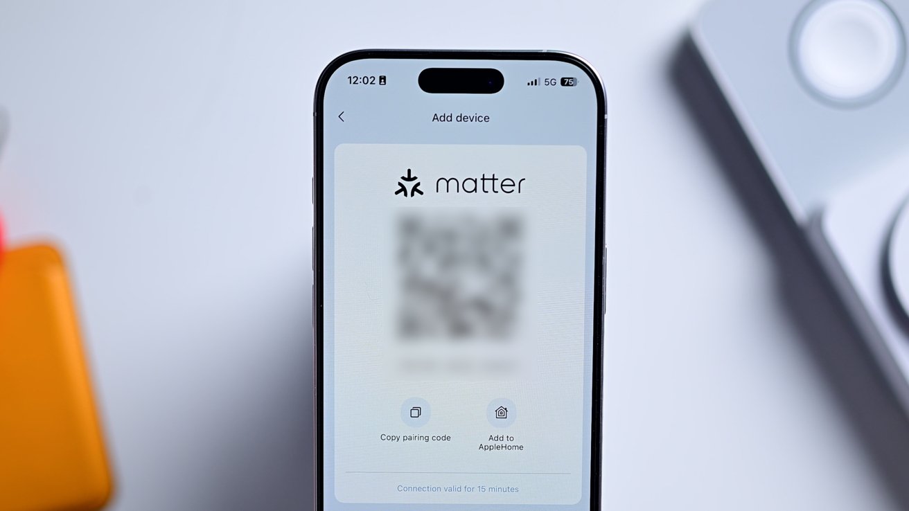 An iPhone showing a blurred out Matter setup code